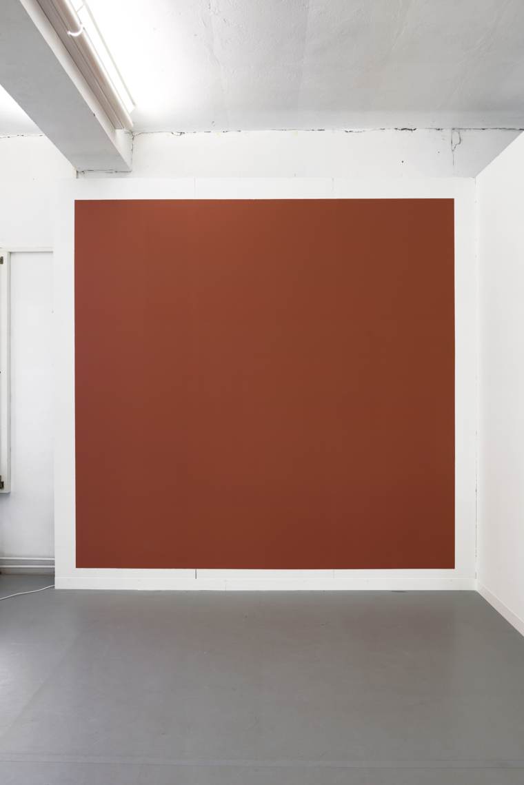Large terracotta wall painting in a white gallery space
