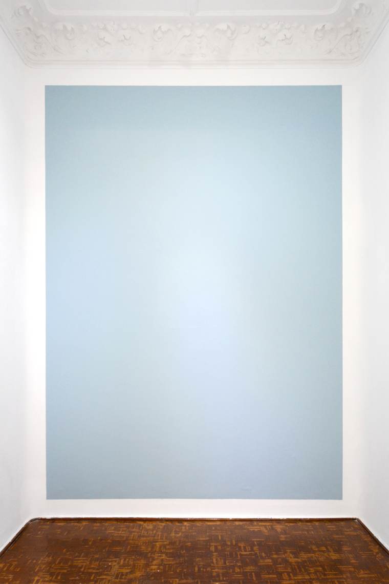 Pale blue wall painting beneath an ornamental plaster cornice