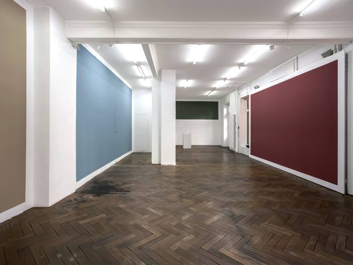 Gallery interior with large wall paintings