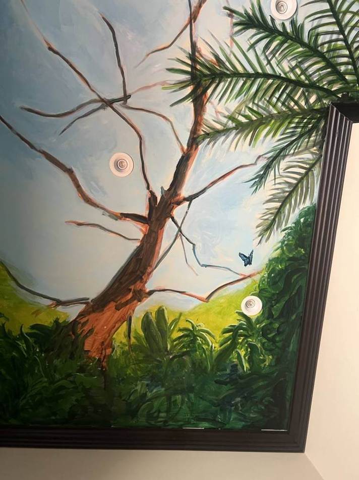 Detail of painted tree and butterfly at the ceiling edge